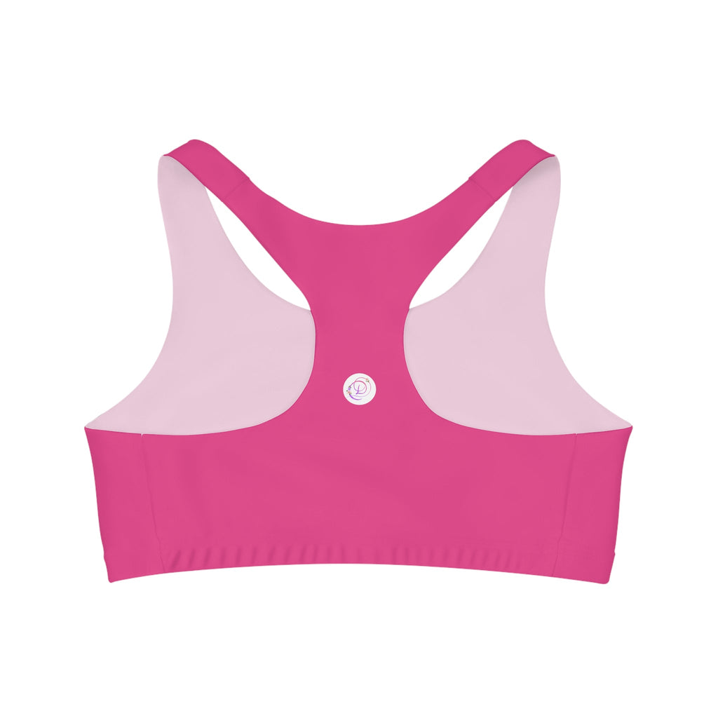 A bright pink Barbie inspired racerback sports bra for women with a dancewear store logo on the back.