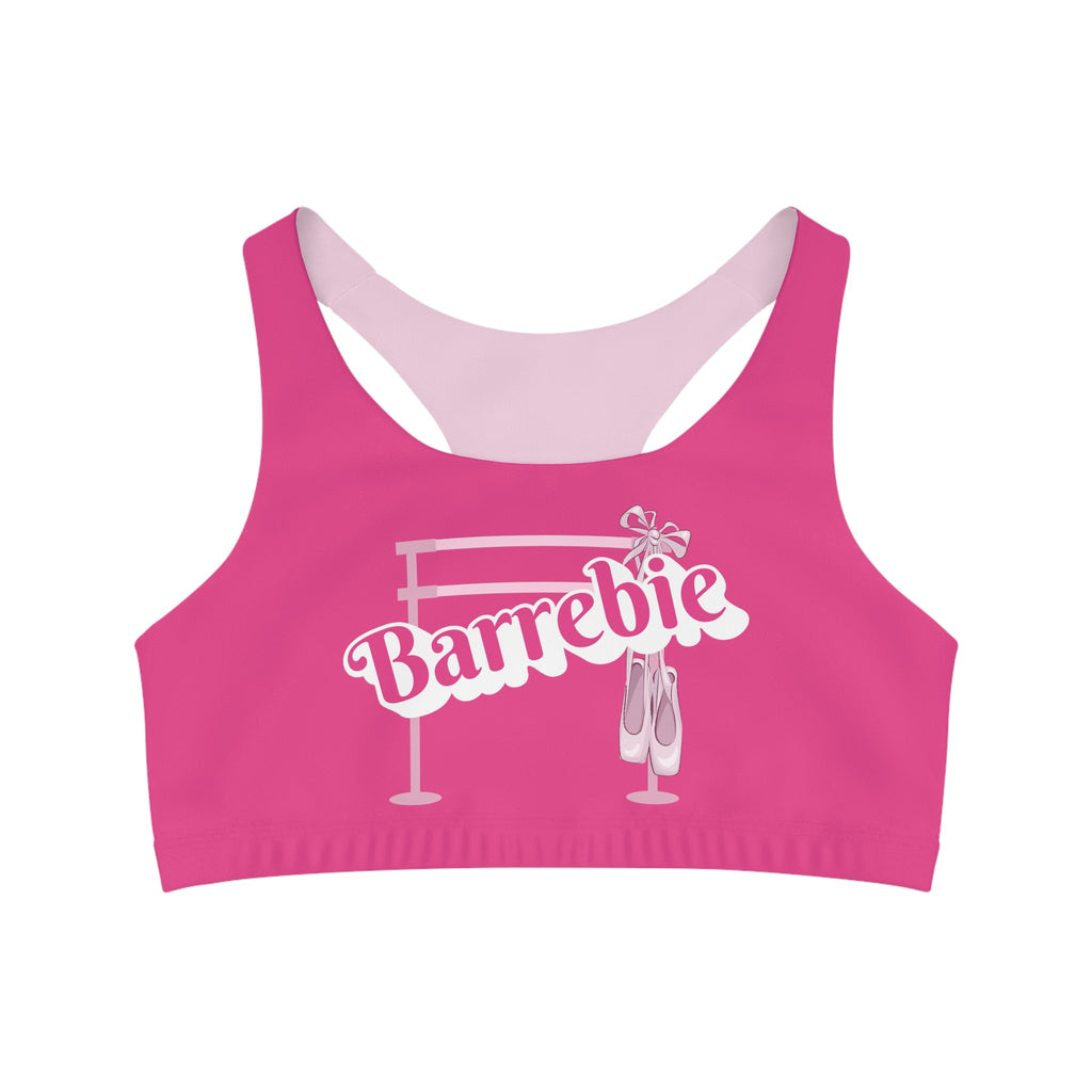 A bright pink barbie inspired sports bra and crop top for women. It features a ballet barre and pointe shoes.