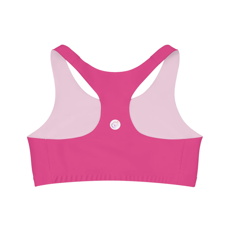 A bright pink Barbie inspired racerback sports bra for women with a dancewear store logo on the back.