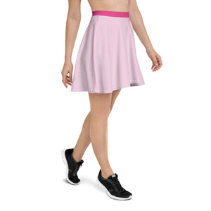 A woman wearing a flowy, pastel pink skater skirt with a Barbie pink, stretchy waistband. 