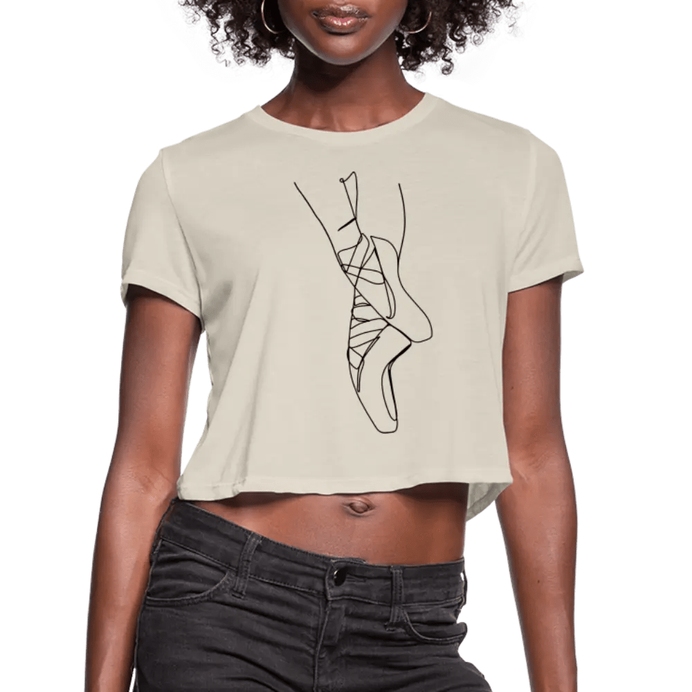 ballet pointe shoe line art on an ultra-soft and flowy sand-colored crop top, modelled by black ballerina