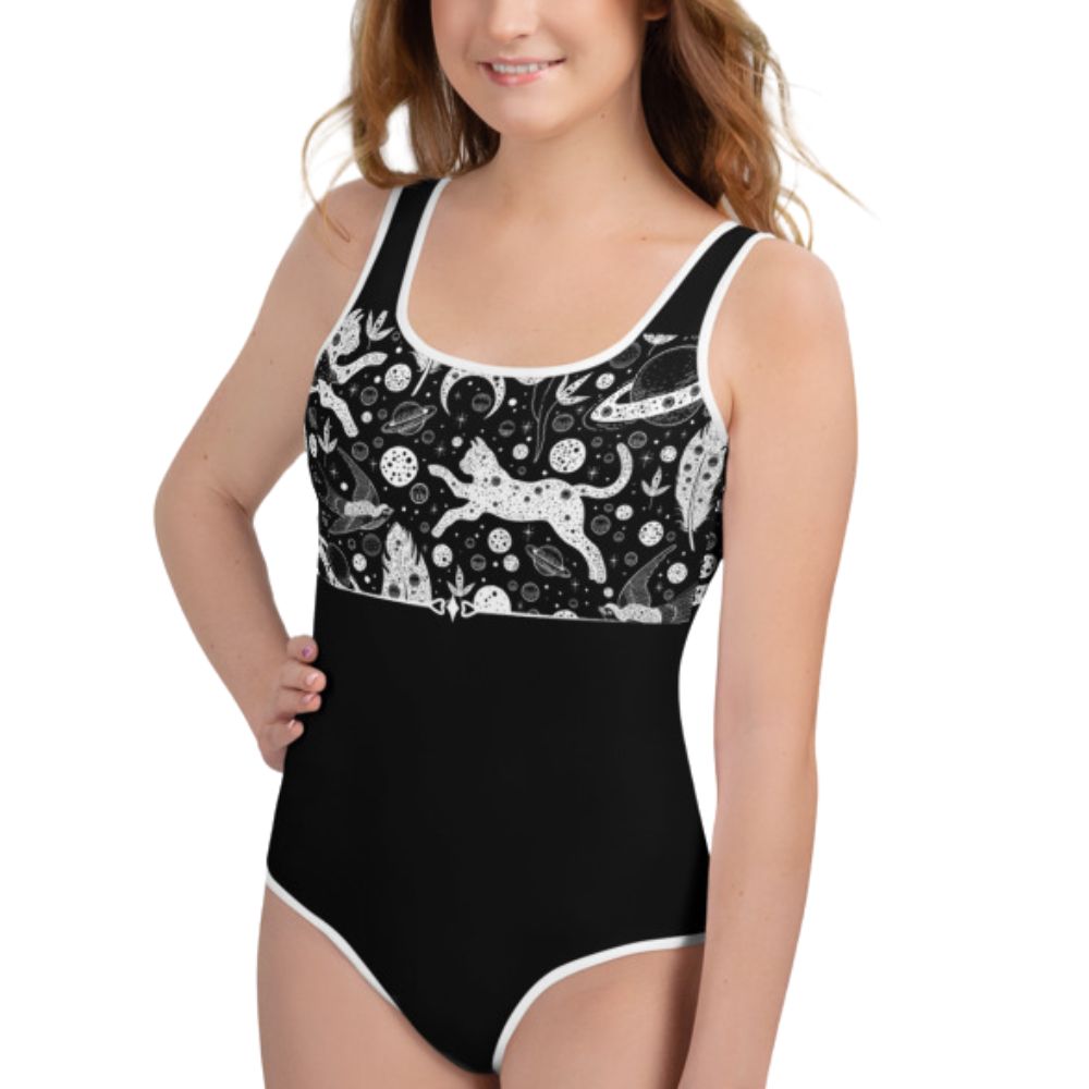 Cute spooky cat pattern on a black and white leotard for Halloween, worn by a model with long hair